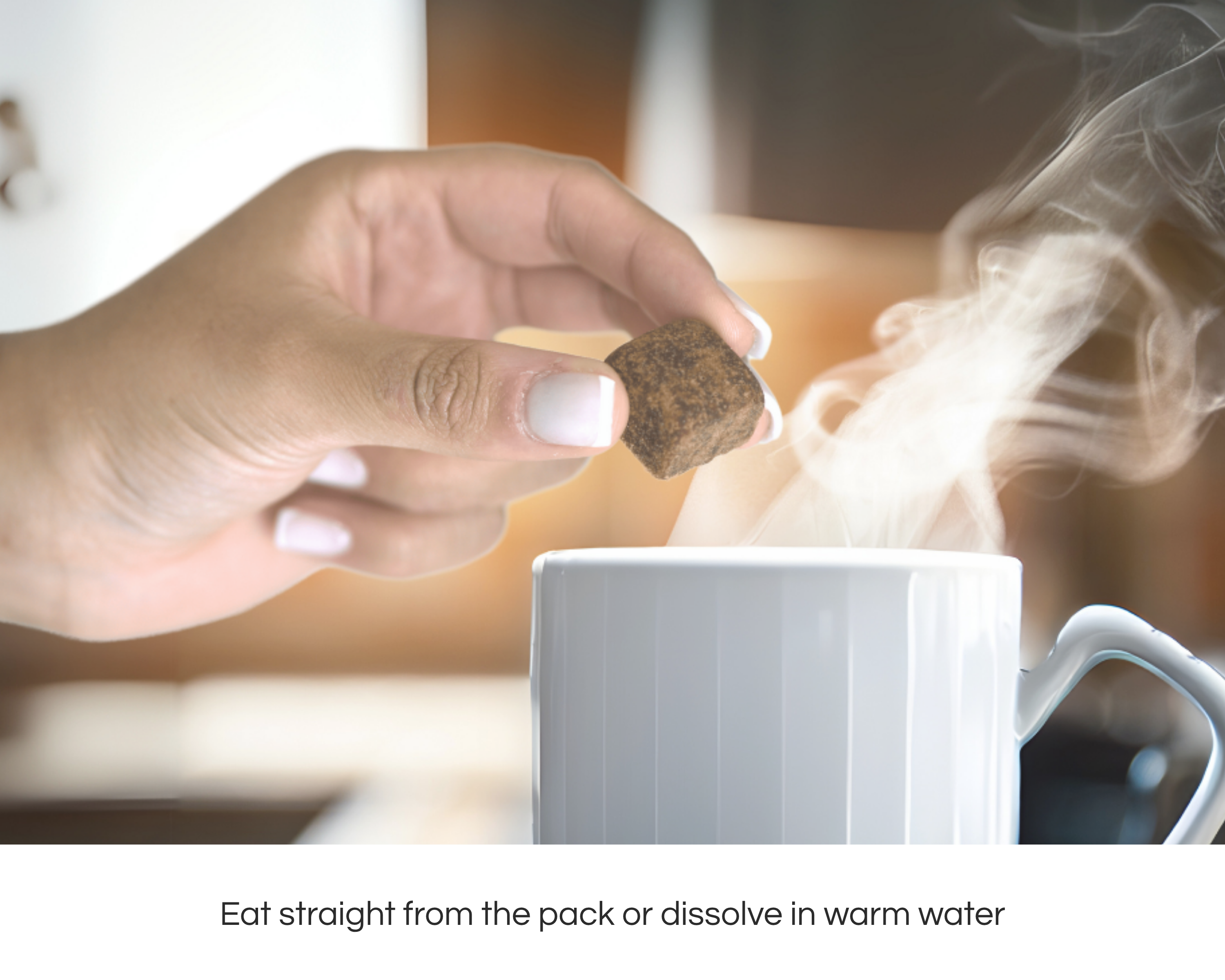 Hand holding a montheaze cube above a steaming cup of tea with text about consumption methods.